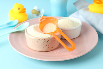 Concept of baby food with рowdered milk on blue background