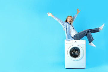 Concept of housework with washing machine and girl on blue background - obrazy, fototapety, plakaty