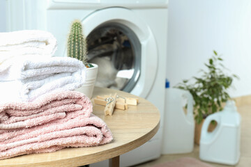 Concept of housework with washing machine against white wall