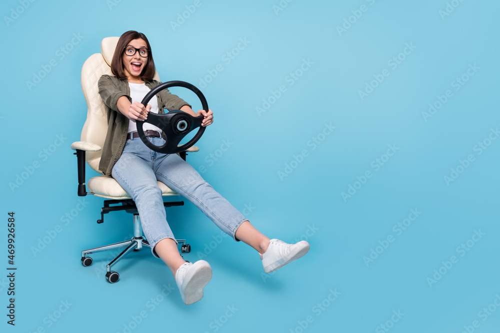 Poster Full size photo of shocked surprised lady sit chair ride steering wheel taxi car wear khaki clothes isolated over blue color background