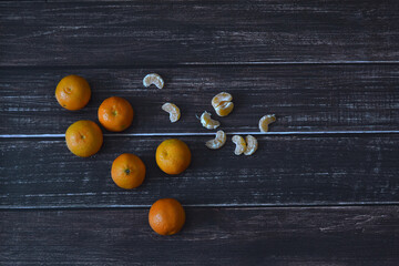 Fototapeta na wymiar small tangerines on wood texture