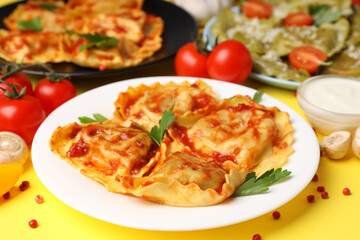 Delicious food concept with ravioli on yellow background