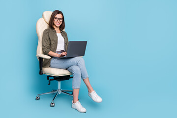 Fototapeta na wymiar Full body photo of ceo lady sit chair use device texting typing message wear khaki denim outfit isolated over blue color background