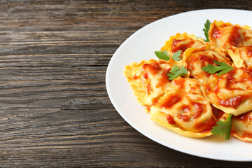 Delicious food concept with ravioli on wooden table