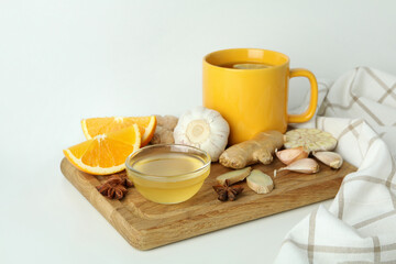Concept of treatment colds with honey and garlic on white background