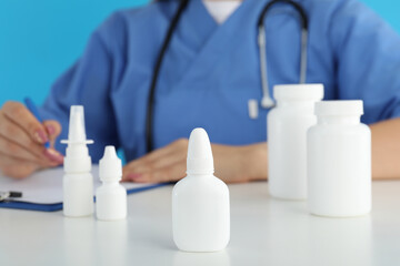 Young nurse sitting at the table, seasonal cold treatment