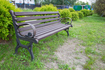 Wooden bench in a summer park.