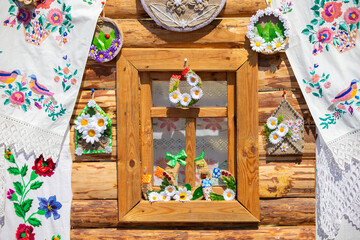 Part of a rustic window of a house decorated with towels.