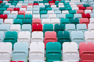 Fototapeta premium colored chairs at the football stadium. red green white