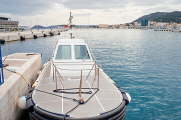 Fototapeta premium Wharf with moored boat at harbour.