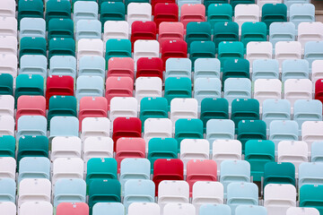 colored chairs at the football stadium. red green white