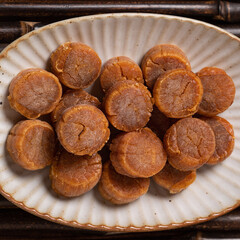 Dried scallop on wooden table.