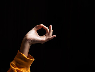 Woman holding om mudra on black background. Relaxation, concentration concept.
