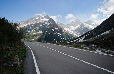Fototapeta premium Asphalt road in Alp mountains. Road trip concept. Beautiful landscape.