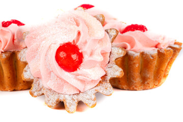 Beautiful sweets. Cakes basket with pink cream decorated with red berries.