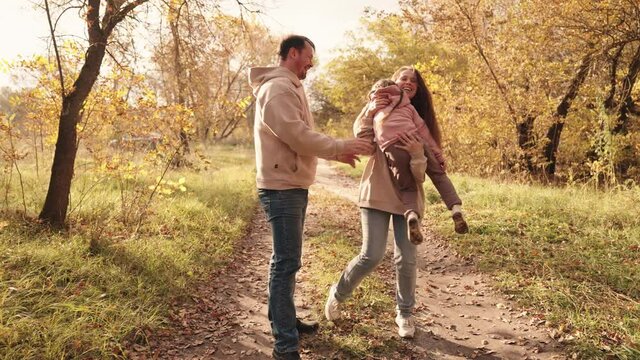 little kid runs catching up with mother and father, happy family, active children outdoor games autumn, cheerful joyful child with mom and dad laughing, vacation travel together, children dream fun