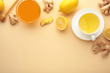 Obraz na płótnie Canvas Ginger tea with lemon in a white cup on beige background.