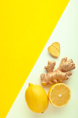 Lemon and ginger on white and yellow background. Vertical photo