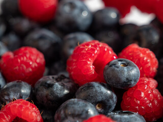 Fresh mixed berries as a background. Blueberries and raspberries.