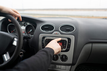 driver hand adjusting car multimedia, turn on radio