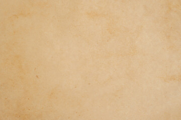 Aged texture of old vintage brown parchment paper, can be use as abstract background, wallpaper,  webpage, copy space for text.