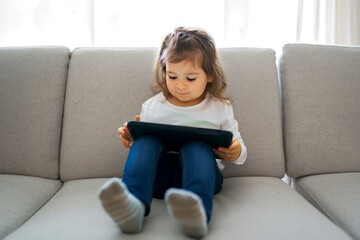 Obraz premium little student girl with tablet pc at home