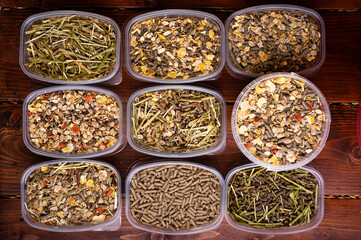 different various of muesli and granules for horses served in tester's boxes. close up . feeding...