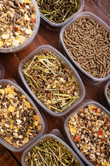 different various of muesli and granules for horses served in tester's boxes. close up . feeding and horse care concept. top view