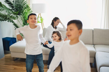 Fototapeta premium living room desperate mother with kid around look like crazy