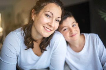 Mother with her son having fun in living room at home