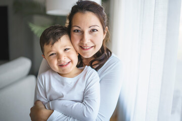 Mother with her son having fun in living room at home