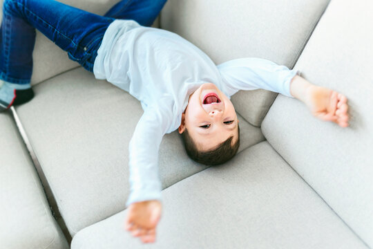 Little crazy boy on living room look like hyperactive
