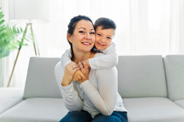 Mother with her son having fun in living room at home