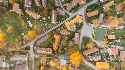 Aerial view of a small village.Top view of traditional housing estate in Czech. Looking straight down with a satellite image style.Houses from above, real estate concept.Country road urban scene