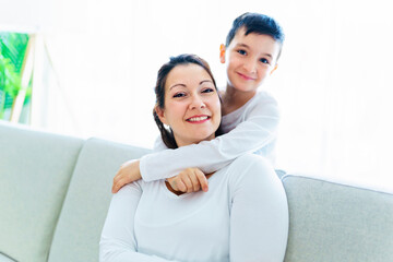 Fototapeta premium Mother with her son having fun in living room at home