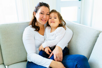 Mother with her daughter having fun in living room at home
