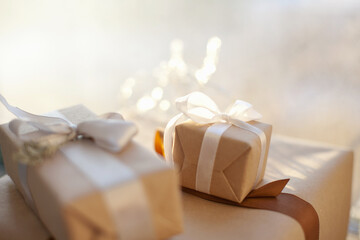 gift box with ribbon and bow and christmas lights. Gift giving concept.
