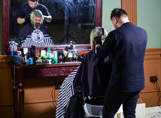 brutal bearded man at hairdresser salon with master, lifestyle