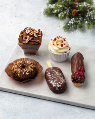 Christmas assorted cakes on a white background with a Christmas decoration or winter holidays pastry food concept.