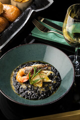 seafood risotto and glass of white wine