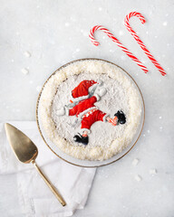 Christmas white cake decorated with the figure of Santa Claus on a white background with a Christmas decoration or winter holidays pastry food concept. Tpo view
