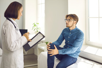 Female doctor in white medical uniform talk consult male patient in private clinic. Woman GP therapist have consultation do regular checkup for man client in hospital. Healthcare, medicine concept.
