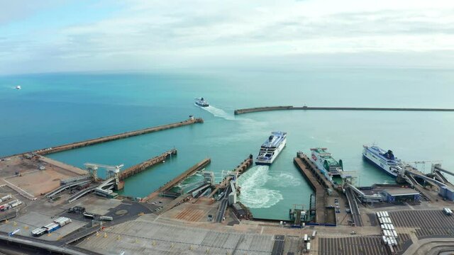 Aerial view of the Dover harbor with many ferries and cruise ships entering and exiting Dover, UK.