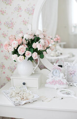 Vintage dressing table with pink roses and pearls jewelry and vintage pocket mirror
