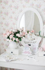 Vintage dressing table with pink roses and pearls jewelry and vintage pocket mirror