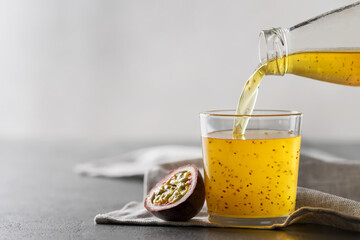 Passion fruit drink with chia seeds. Pour the juice from the bottle into a glass.
