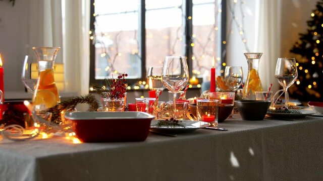 eating, winter holiday and celebration concept - christmas dinner party table serving at home over snow