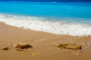Summer seascape beautiful waves, blue sea water in sunny day. View of beautiful bright sea with waves splashing and beach sand.