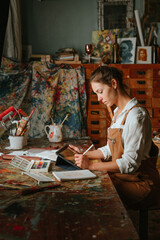 Portrait of female artist using tablet for sketching