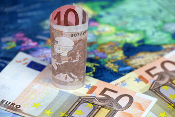 Euro banknotes on the Europe map. Concept of Eurozone, European economy, stock market in EU